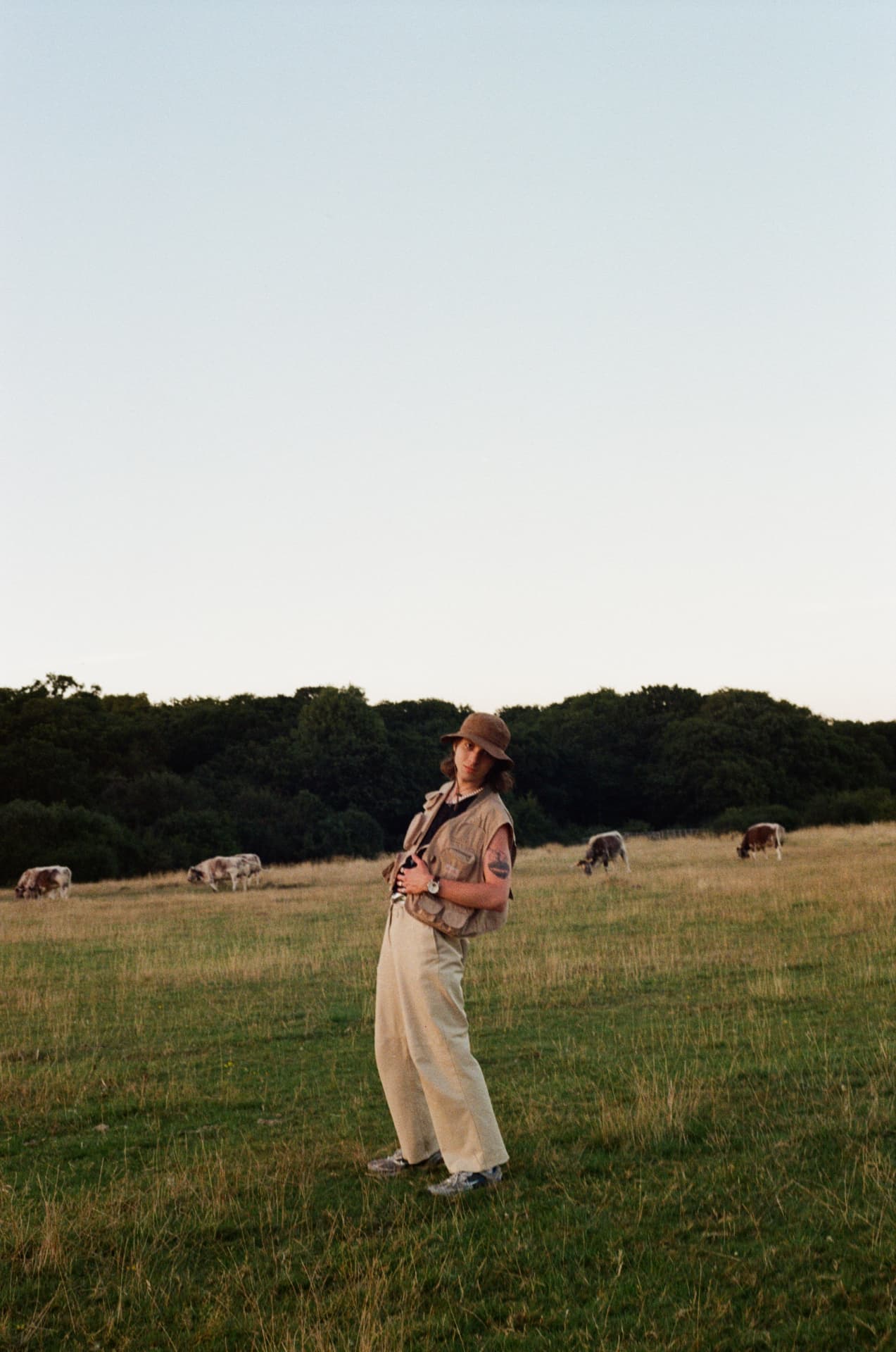 Portrait — figure in a field at dusk