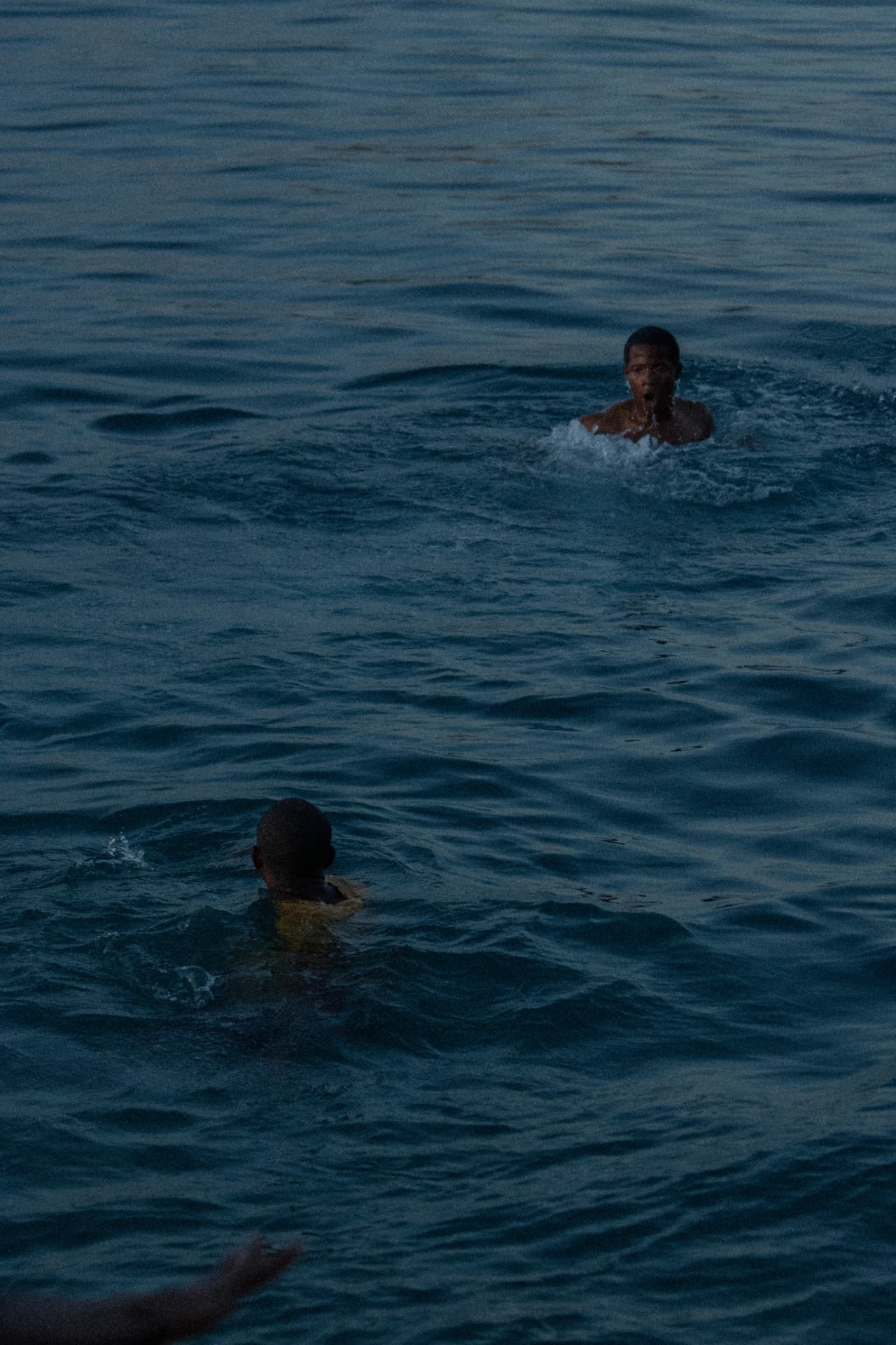Still — two swimmers at dusk