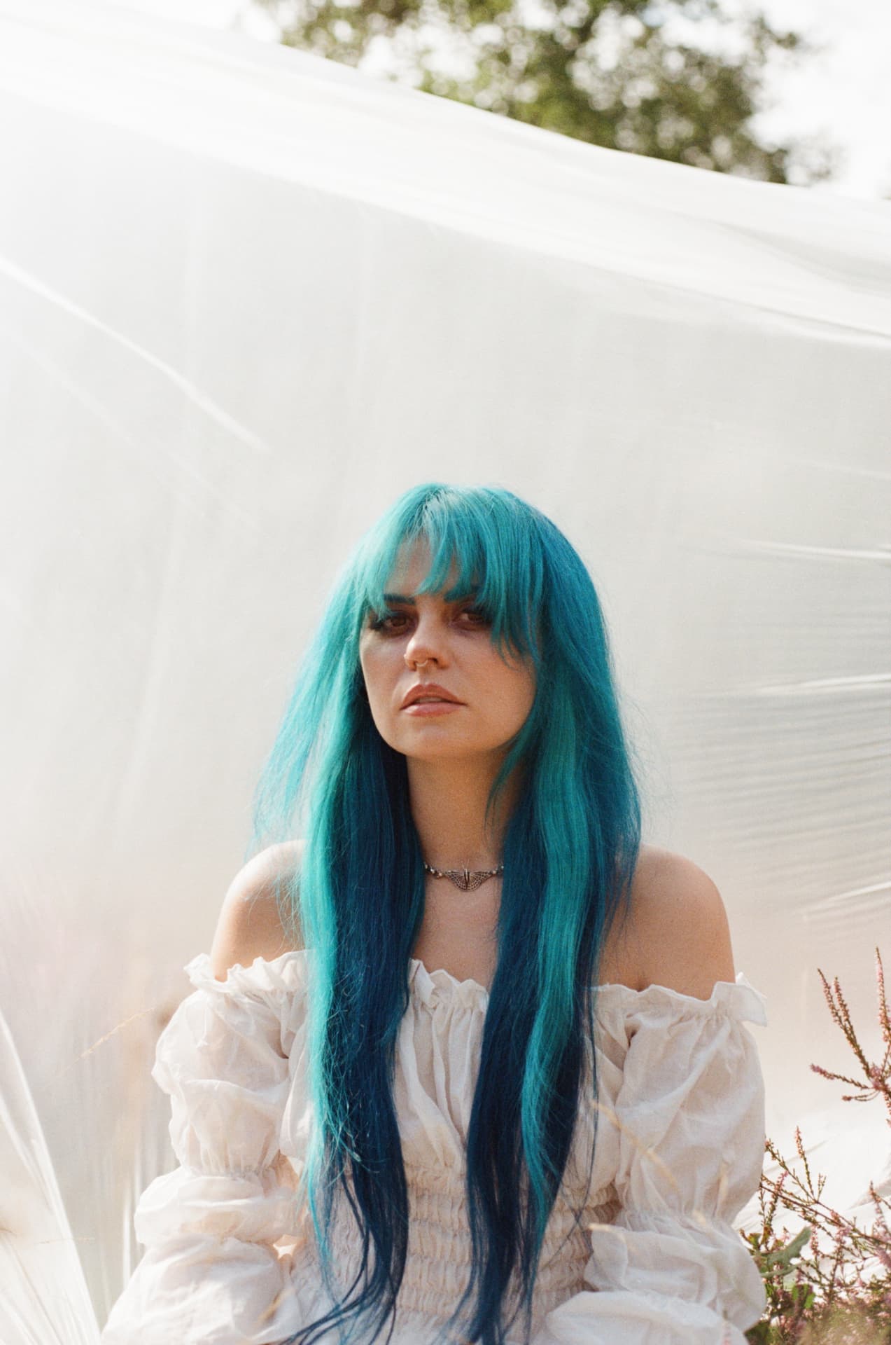Portrait — blue hair against white sheet