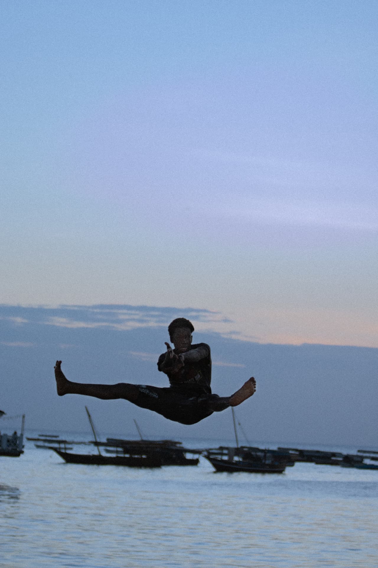 Portrait — figure leaping by the water
